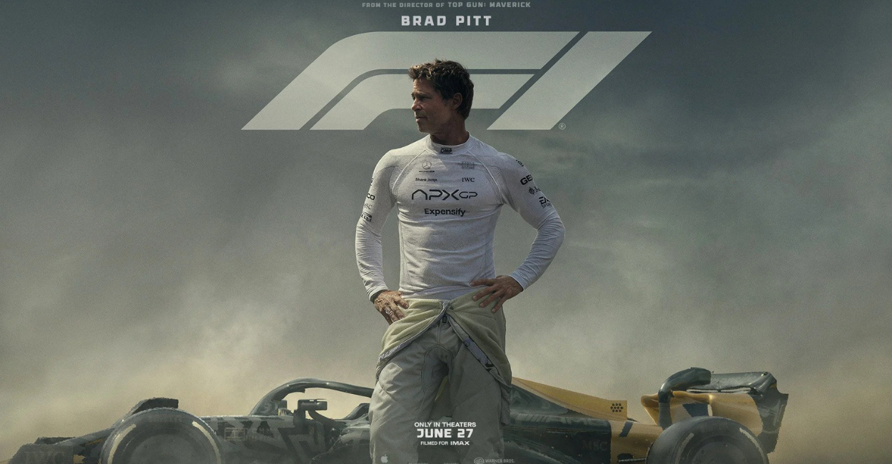 Official poster of F1 movie featuring Brad Pitt in a racing suit standing on a Formula 1 track